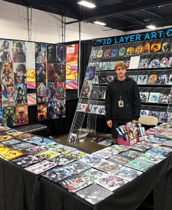 The 3D Layer Art booth with a full wall of layered prints