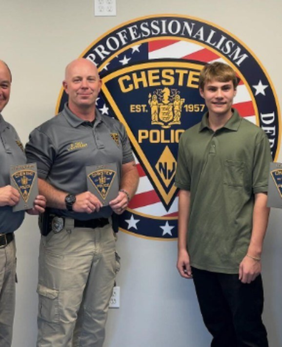 Chester Police Department officers holding layered badge prints